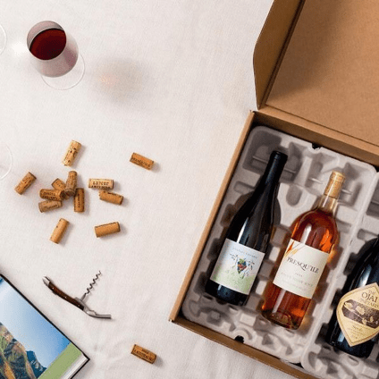 A wine subscription box opened with three bottles of wine to entice customers