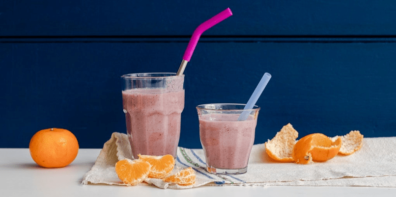 Two smoothies with some oranges on the side with StrawExpert's metal straws, eco-friendly straws ideal for the environment