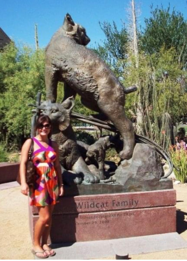 Lexi Sutter posing with the Wildcat Family Statue during her first visit to the University of Arizona in Tucson